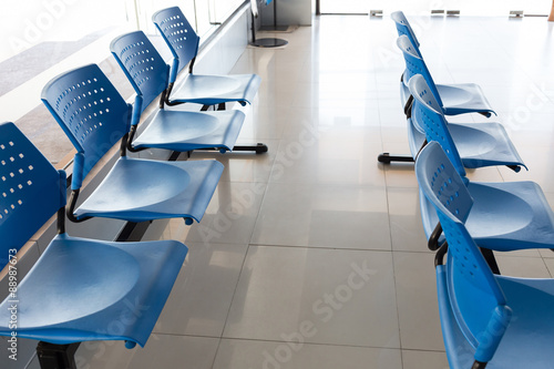 customer waiting area with rows of blue seats in office