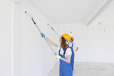 workmen painting wall