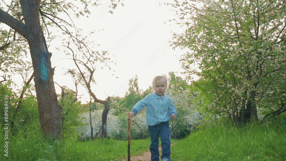 Little Boy Running along the Park Alley Little Boy Running along the Park Alley
