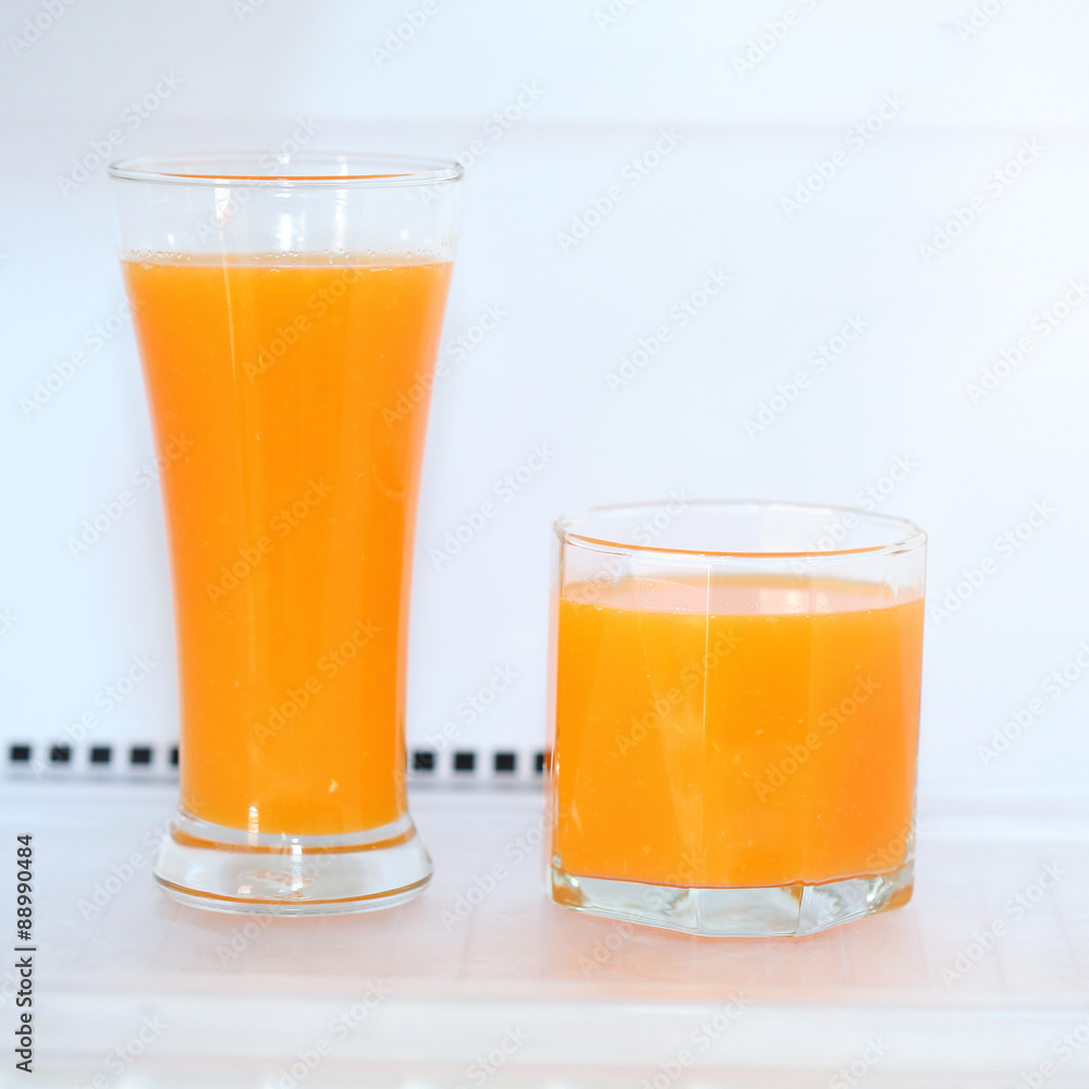 glass of fresh orange juice in refrigerator glass of fresh orange juice in refrigerator