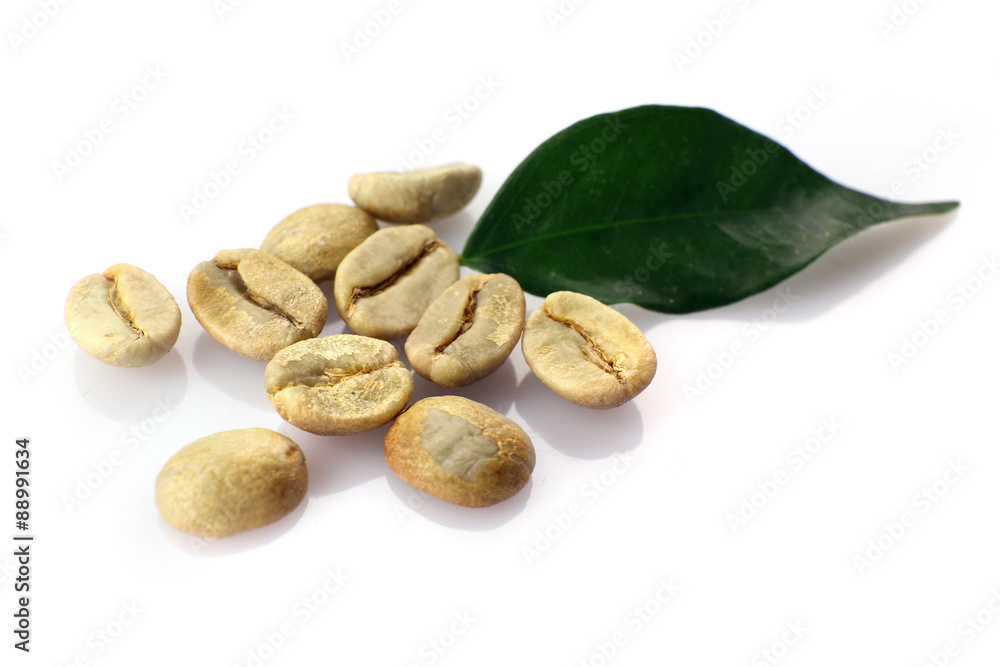 Heap of green coffee beans with leaf isolated on white Heap of green coffee beans with leaf isolated on white