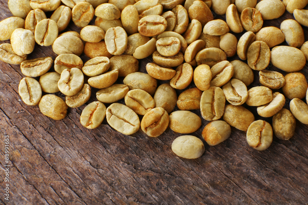 Heap of green coffee beans on table close up Heap of green coffee beans on table close up