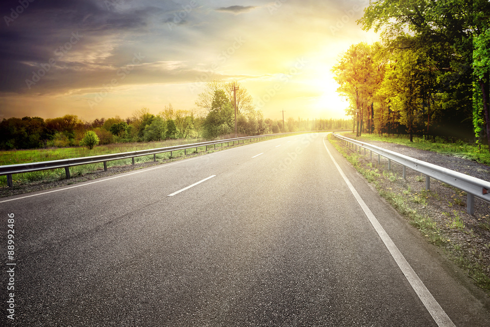 Asphalt road leaving for turn to the sun