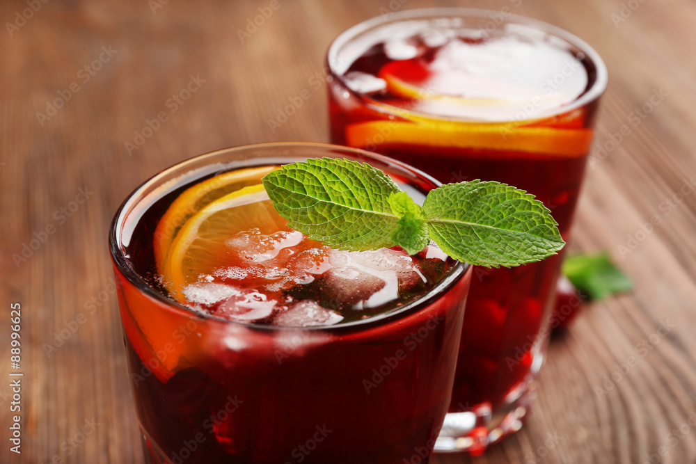 Glasses of cherry juice on wooden background Glasses of cherry juice on wooden background