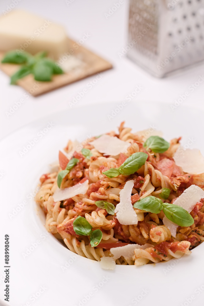 Italian homemade pasta with tomato sauce, basil and parmesan cheese. Concept of everyday dining. Italian homemade pasta with tomato sauce, basil and parmesan cheese. Concept of everyday dining.