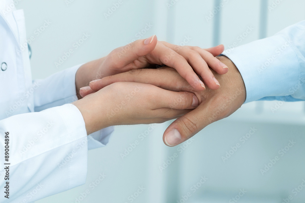 Female medicine doctor reassuring her patient. Hands close-up. Healthcare and medical concept. Female medicine doctor reassuring her patient. Hands close-up. Healthcare and medical concept.