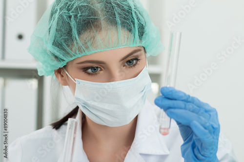 Medical doctor in protective gloves and surgical mask and hat lo