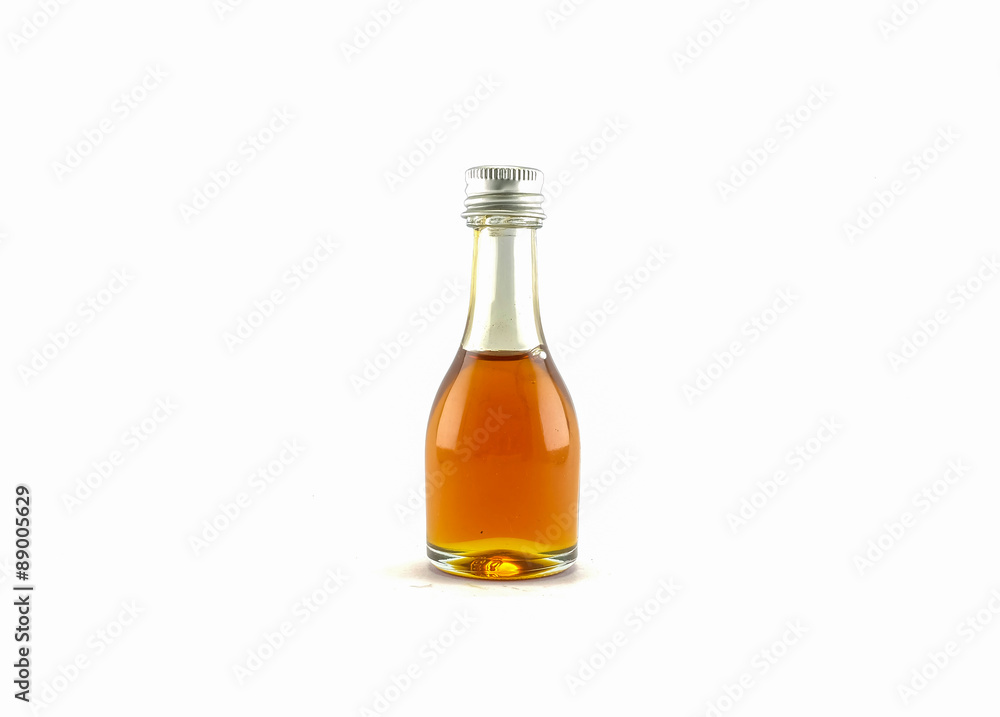 Honey in a glass bottle isolated on white background Honey in a glass bottle isolated on white background