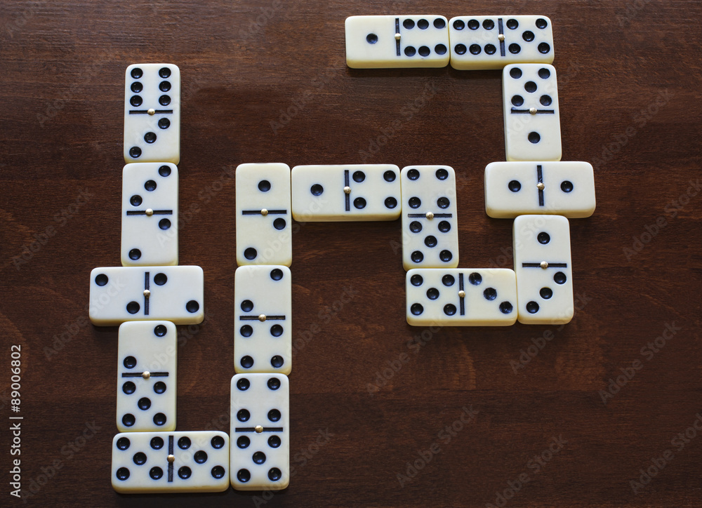 domino pieces on the brown wooden table background domino pieces on the brown wooden table background
