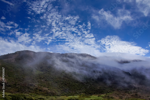 Foggy Ridge, Wispy Clouds, Blue Sky and Green Meadows. Marin Headlands, California