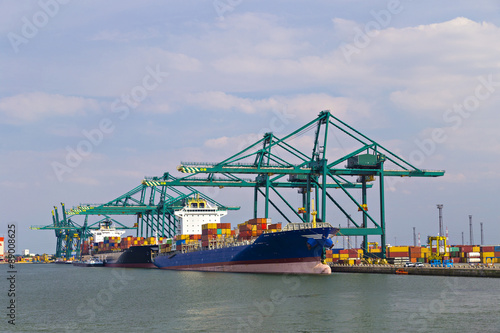 Huge container ship loaded with cranes in Antwerp container terminal