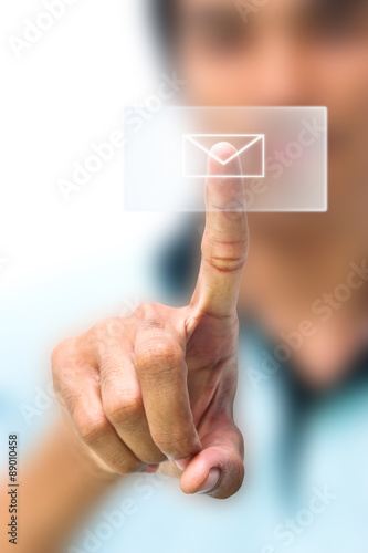 Man pushing email icon on touch screen pad