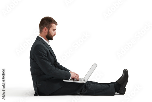 man in formal wear sitting on the floor