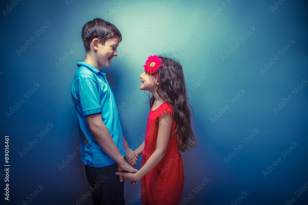 teen girl holding hands teenage boy on a gray background retro p Stock ...