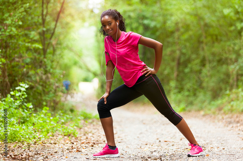  African american woman jogger stretching - Fitness, people and