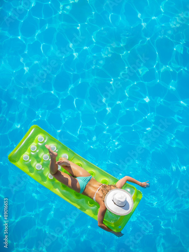 A girl is relaxing in a swimming pool