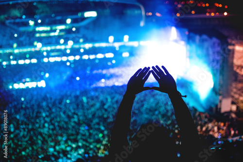 Canvastavla Man showing love at concert, silhouette of hands making gestures with lights bac