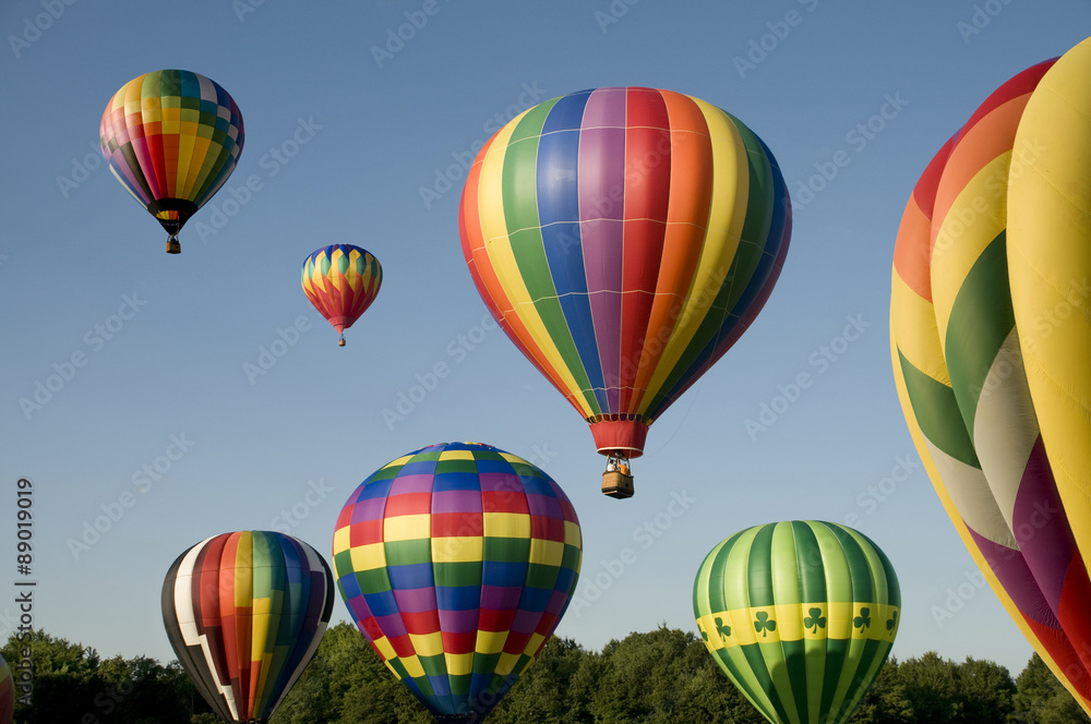 Fototapeta premium Hot-air balloons ascending or launching at a ballooning festival