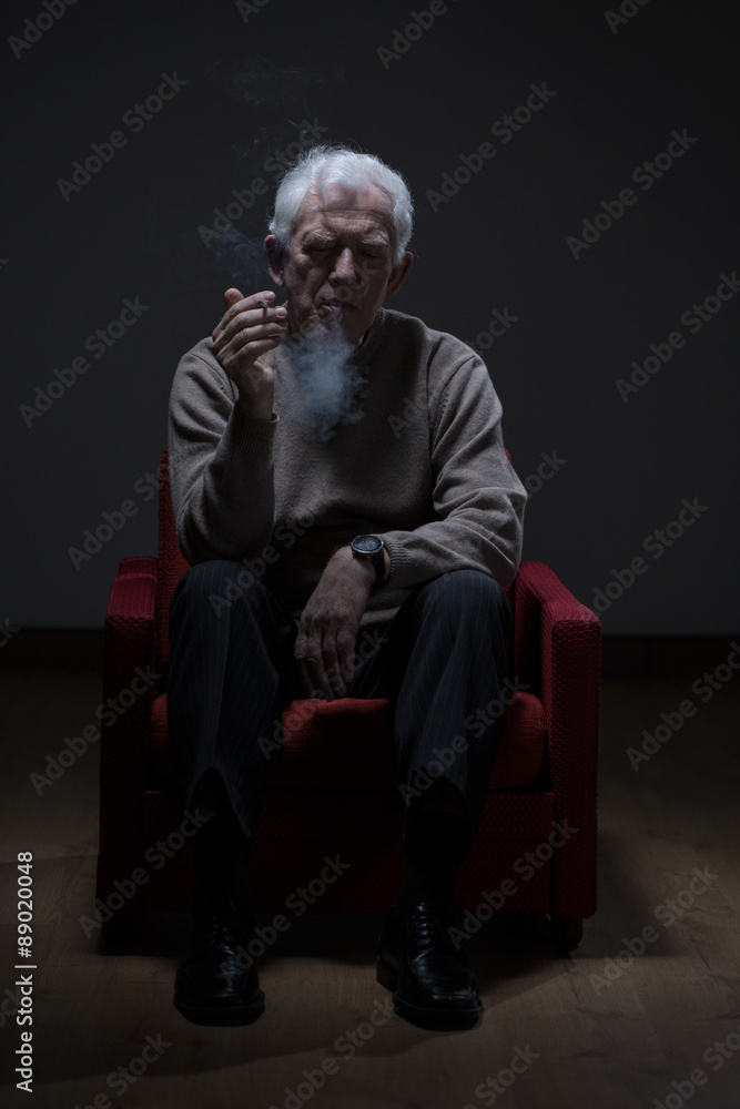 Senior man smoking cigarette Senior man smoking cigarette