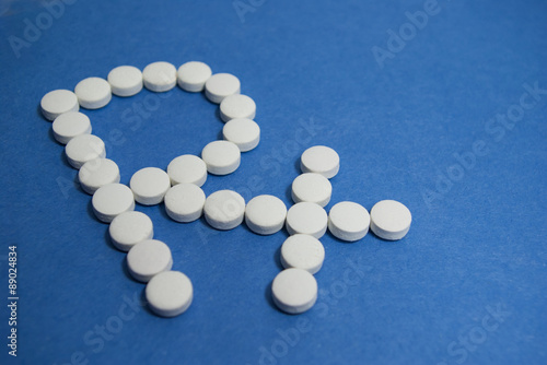 RX symbol in white pills on blue background