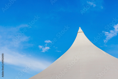 The top of big canvas event tent under the beautiful clear blue