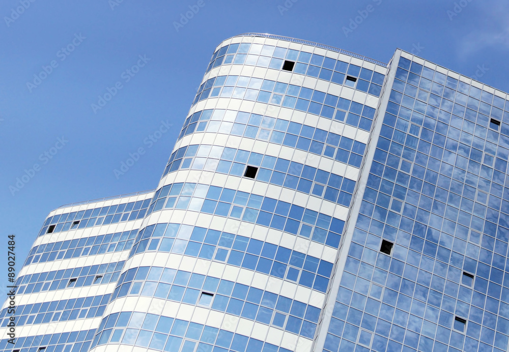 Fototapeta premium Exterior of high office building against blue sky