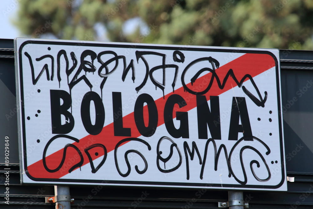 Bologna, road sign smeared with graffiti.
