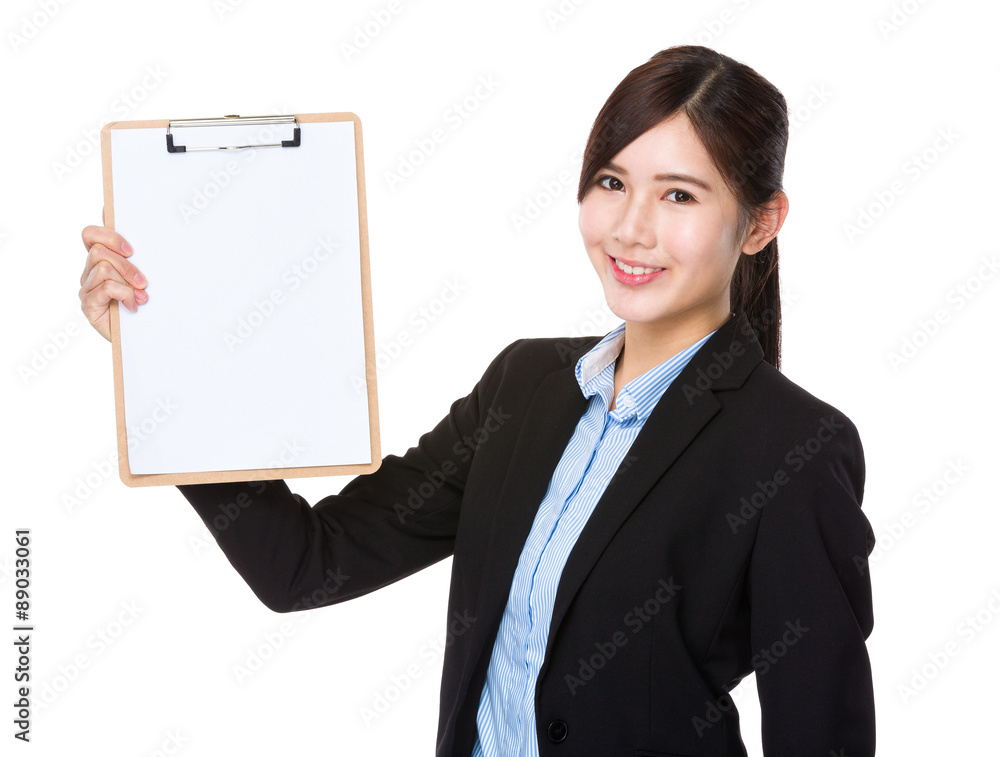 Businesswoman showing with blank page of clipboard Businesswoman showing with blank page of clipboard