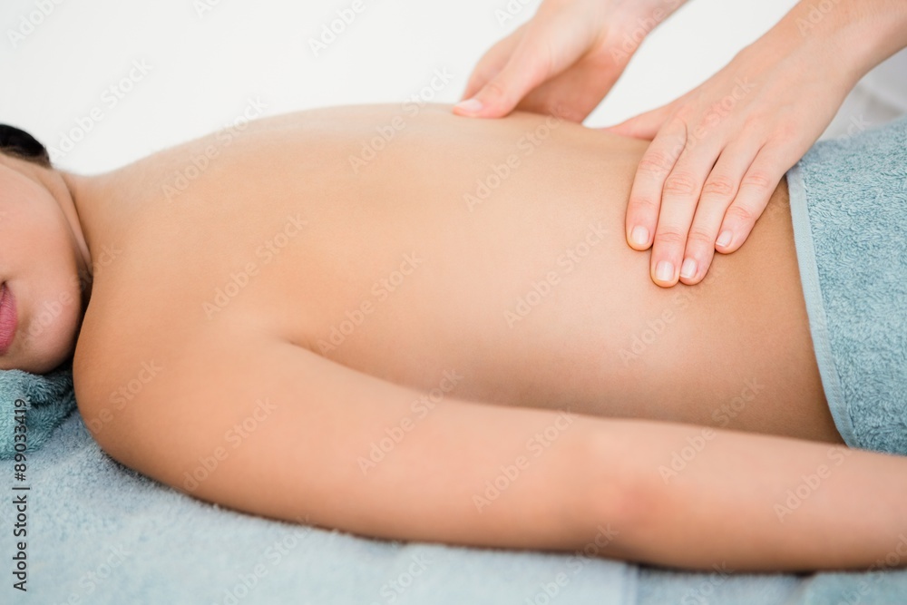 Attractive woman receiving back massage at spa center Attractive woman receiving back massage at spa center