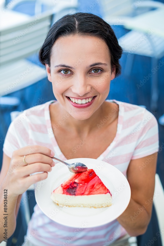 Smiling brunette taking a piece of chocolate cake Smiling brunette taking a piece of chocolate cake