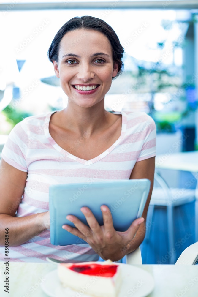 Happy woman enjoys using her tablet Happy woman enjoys using her tablet