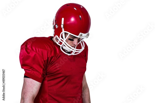 Unsmiling american football player looking down