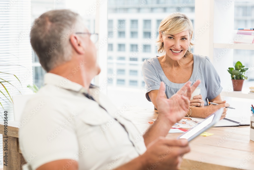 Smiling business team discussing together Smiling business team discussing together