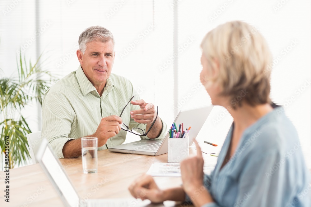 Casual business team discussing together Casual business team discussing together