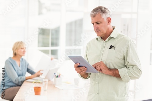 Attentive businessman working on the tablet