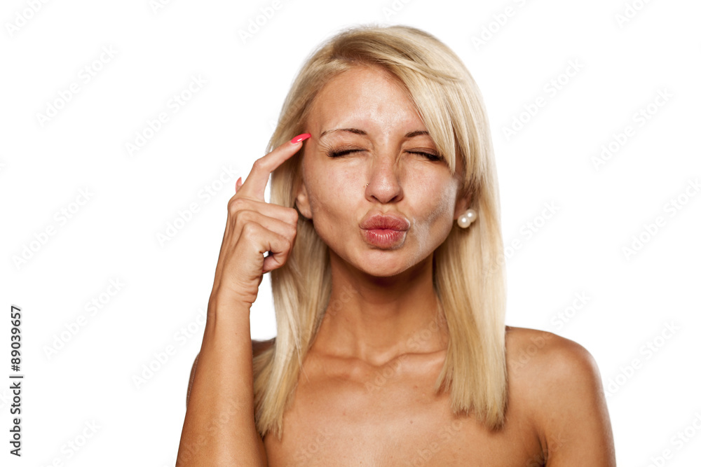 thoughtful young blonde with no makeup on a white background thoughtful young blonde with no makeup on a white background