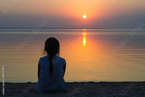 Girl at the sea at sunset © rm211171