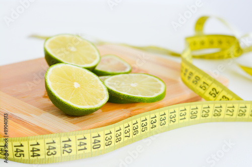 Measurement of diet results concept with fruits on wooden cutting board