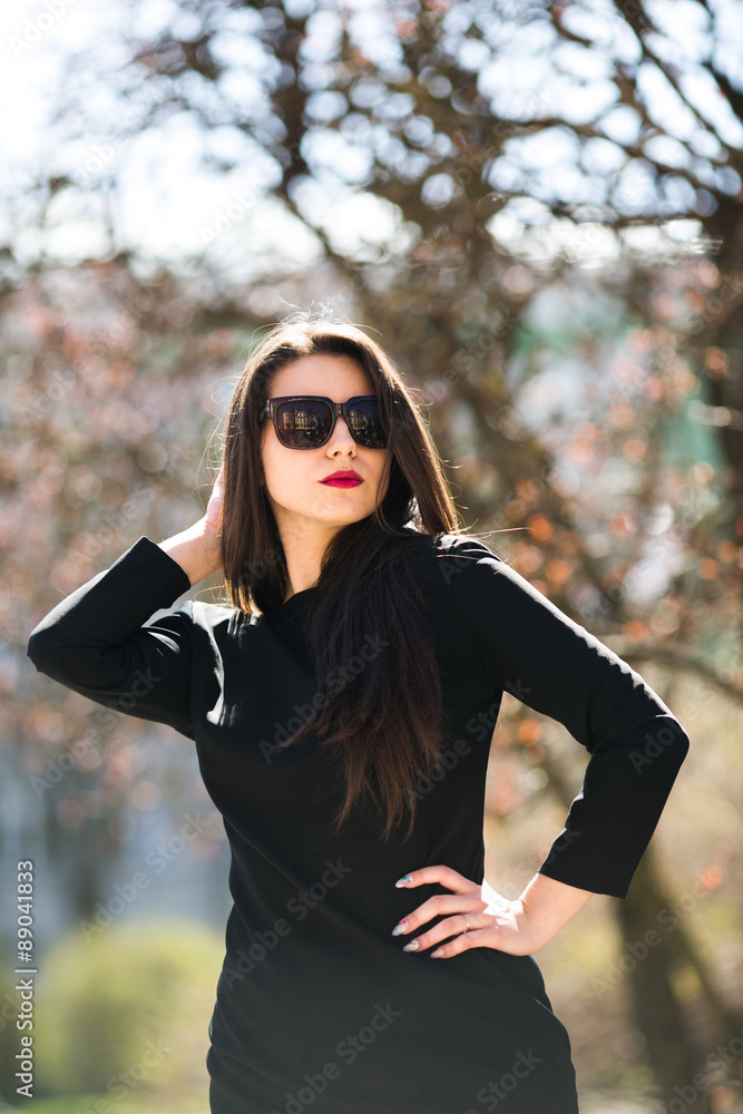 Glamorous young woman in black leather jacket and sunglasses Glamorous young woman in black leather jacket and sunglasses