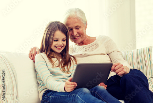 smiling family with tablet pc at home © Syda Productions
