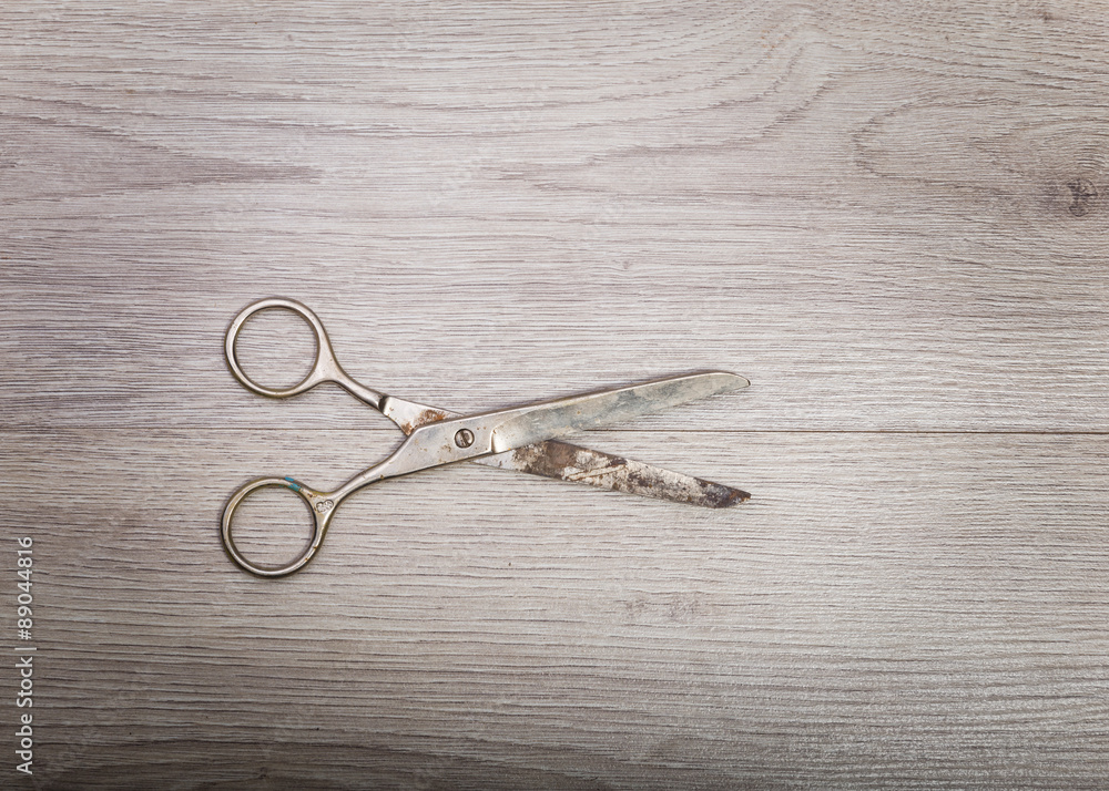 Scissors sits on a wood table Scissors sits on a wood table