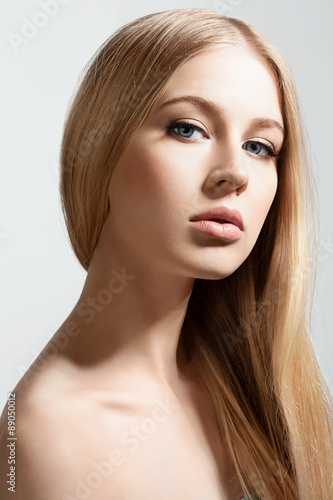 Beautiful face of blond woman with long healthy and shiny hair