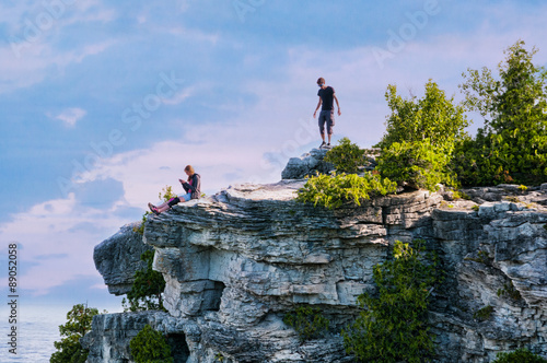 two teens standing on high cliff lookout at Bruce Peninsula National Park
