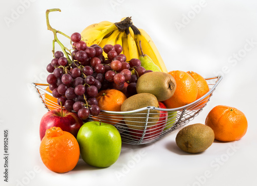 Fototapeta Naklejka Na Ścianę i Meble -  Composition with assorted fruits in  basket isolated on white