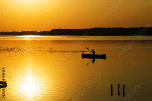 Silhouette of kayak on lake 