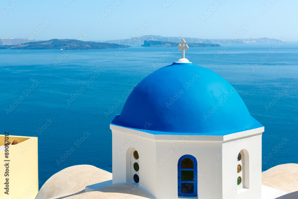 Greek church with blue dome in Oia, Santorini