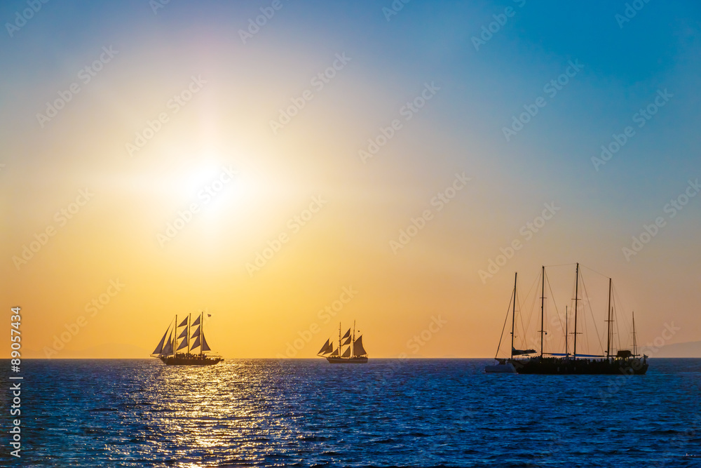 Sailing ships on the sea in sunset