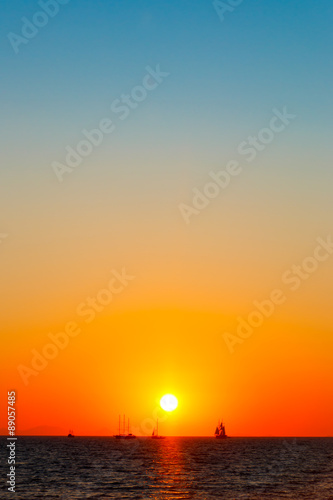 Far away ships on the sea in sunset