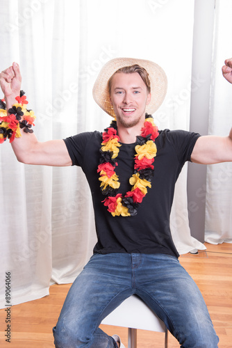 young german football fan holding up his arms photo