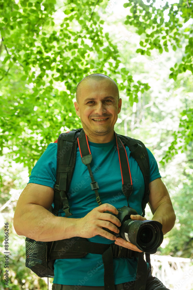 Tourist with camera on a trail Tourist with camera on a trail